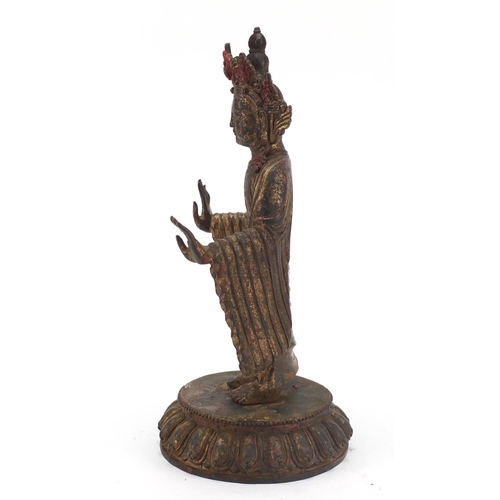 576 - Chino-Tibetan gilt bronze figure of standing Buddha with remnants of paint, 34cm high