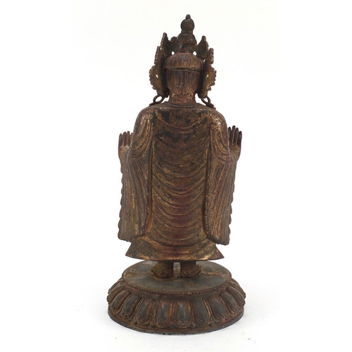 576 - Chino-Tibetan gilt bronze figure of standing Buddha with remnants of paint, 34cm high