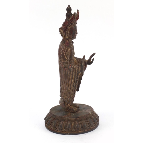 576 - Chino-Tibetan gilt bronze figure of standing Buddha with remnants of paint, 34cm high