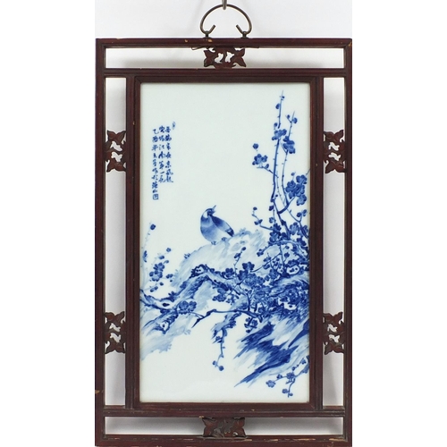 212 - Chinese blue and white panel housed in a carved hardwood frame, hand painted with a bird on a rock w... 