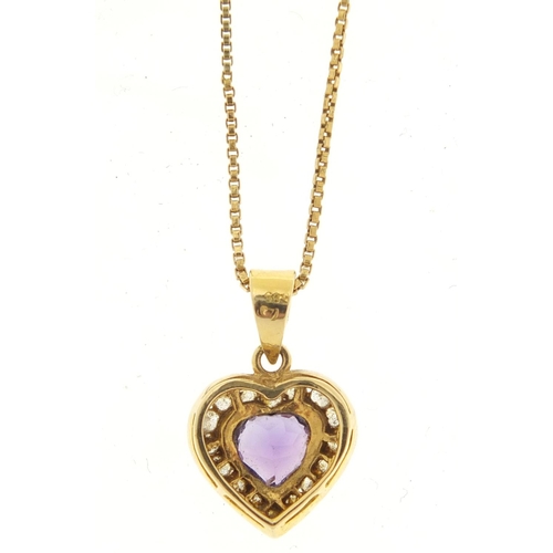 605 - 14ct gold amethyst and clear stone love heart pendant, 2cm in length on an unmarked gold coloured me... 