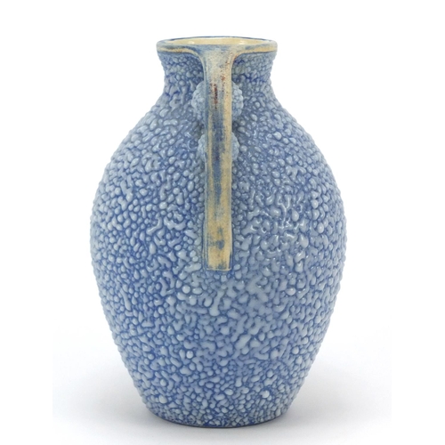 105 - French Art Deco twin handled pottery vase having a blue glaze, numbered 595 to the base, 19.5cm high