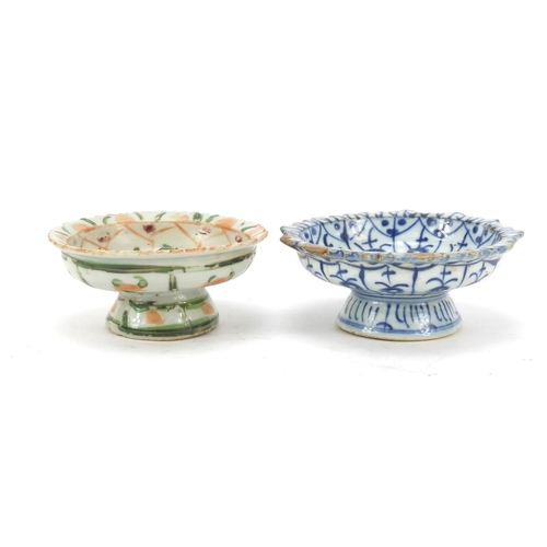 574 - Two Chinese porcelain pedestal dishes hand painted with flowers, the largest 11cm in diameter