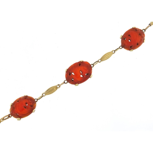 163 - 14ct gold carnelian bracelet carved with birds amongst flowers, 20cm in length, 12.2g