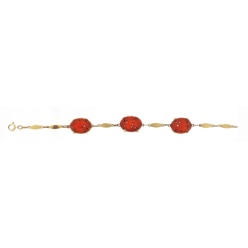 163 - 14ct gold carnelian bracelet carved with birds amongst flowers, 20cm in length, 12.2g