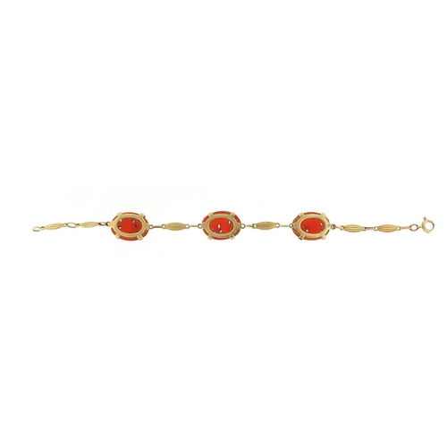 163 - 14ct gold carnelian bracelet carved with birds amongst flowers, 20cm in length, 12.2g