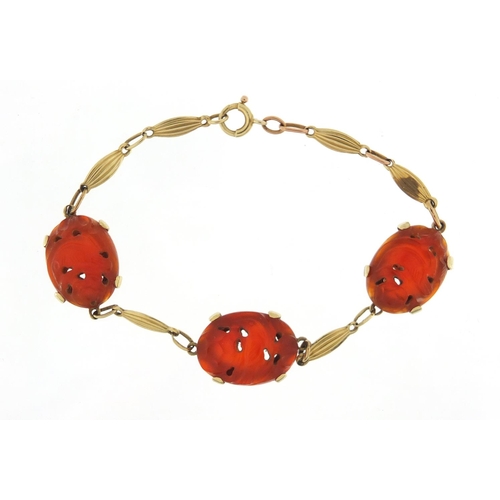 163 - 14ct gold carnelian bracelet carved with birds amongst flowers, 20cm in length, 12.2g