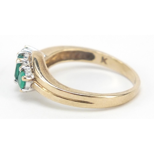 686 - 9ct gold green stone and diamond crossover ring, size M, 2.5g