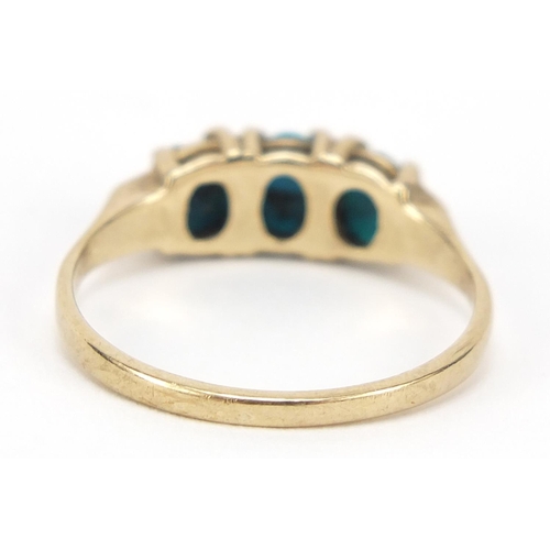 562 - 9ct gold turquoise three stone ring, size O, 2.0g