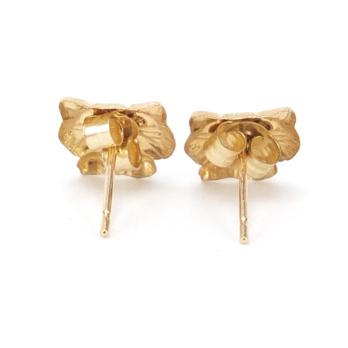 734 - Pair of 9ct gold cat's head stud earrings, 6mm in length, 0.3g