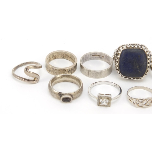 402 - Seventeen silver and white metal rings, some set with semi precious stones, 91.0g