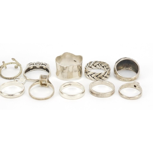 402 - Seventeen silver and white metal rings, some set with semi precious stones, 91.0g