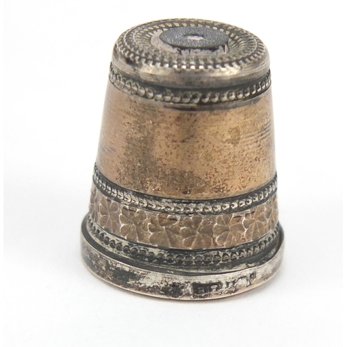 762 - Four silver thimbles including one with a Stanhope and niello work, the largest 2.2cm high, 24.0g