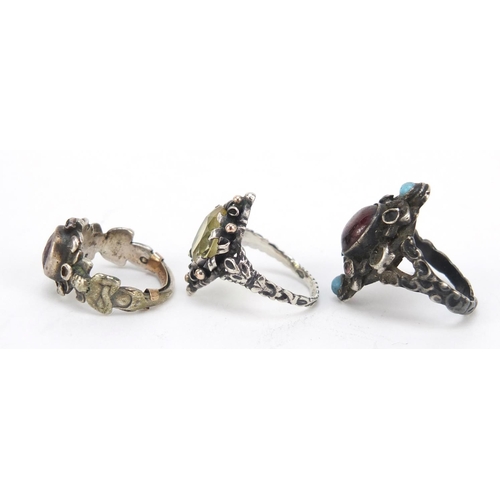 642 - Three silver rings set with semi precious stones including garnet and turquoise, various sizes, 15.6... 