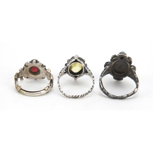 642 - Three silver rings set with semi precious stones including garnet and turquoise, various sizes, 15.6... 