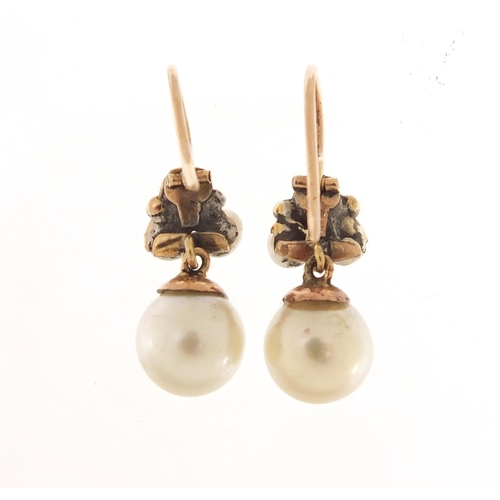 563 - Pair of unmarked gold pearl and diamond drop earrings, 2.5cm in length, 3.5g