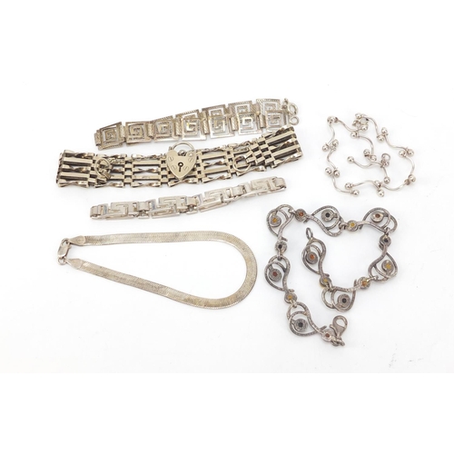 560 - Six silver bracelets including six row gate bracelet and one set with amber, 50.0g