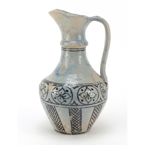 608 - Islamic terracotta jug hand painted with flowers, 24cm high