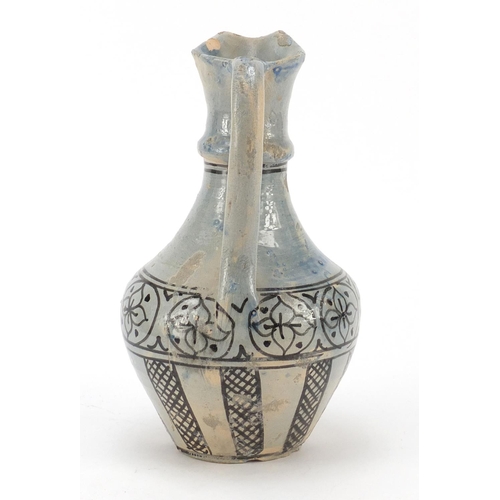 608 - Islamic terracotta jug hand painted with flowers, 24cm high