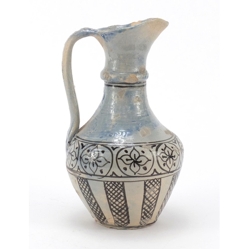 608 - Islamic terracotta jug hand painted with flowers, 24cm high