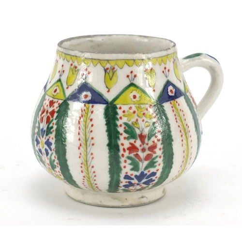 231 - 19th century Turkish Kutahya pottery mug, hand painted with flowers, 11cm high