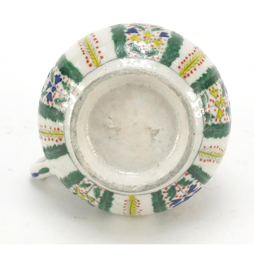 231 - 19th century Turkish Kutahya pottery mug, hand painted with flowers, 11cm high