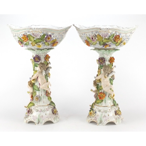 735 - Large pair of Dresden floral encrusted porcelain centrepieces with pierced baskets on naturalistic s... 