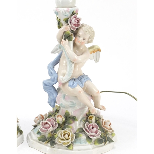 737 - Pair of 19th century porcelain floral encrusted cherub candlesticks by Plaue, converted for electric... 