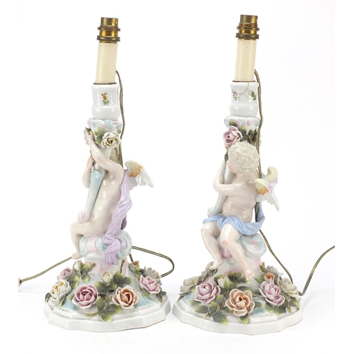 737 - Pair of 19th century porcelain floral encrusted cherub candlesticks by Plaue, converted for electric... 