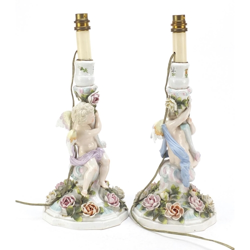 737 - Pair of 19th century porcelain floral encrusted cherub candlesticks by Plaue, converted for electric... 