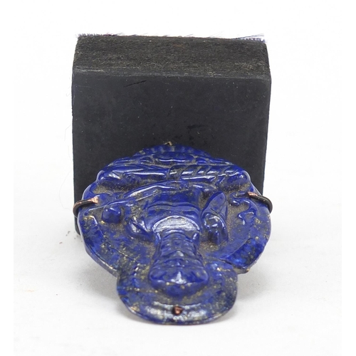 1613 - Chinese lapis lazuli pendant carved with a seated Buddha on stand, the carving 5.2cm high