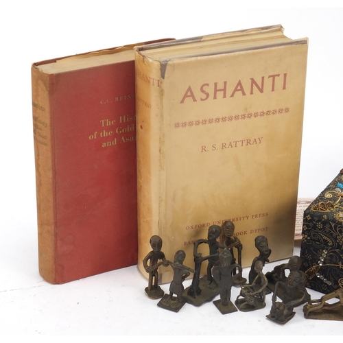 627 - Eleven African bronzed Ashanti gold weights and two reference books, The History of the Gold Coast a... 