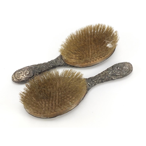 366 - Pair of Victorian silver clothes brushes embossed with Putti and birds amongst flowers, indistinct B... 