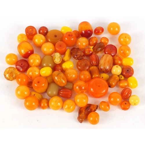 2011 - Loose amber coloured beads, the largest 3cm in length, 280.0g