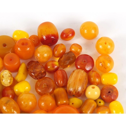 2011 - Loose amber coloured beads, the largest 3cm in length, 280.0g