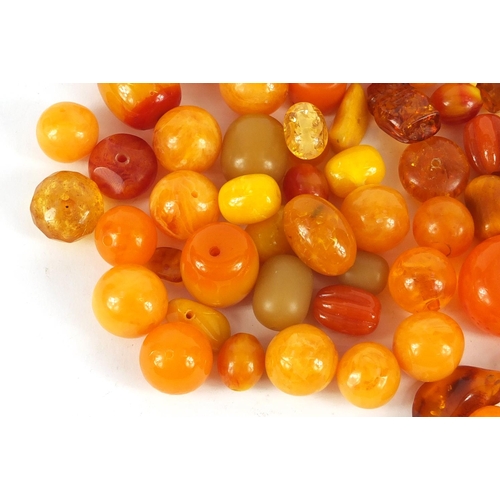 2011 - Loose amber coloured beads, the largest 3cm in length, 280.0g