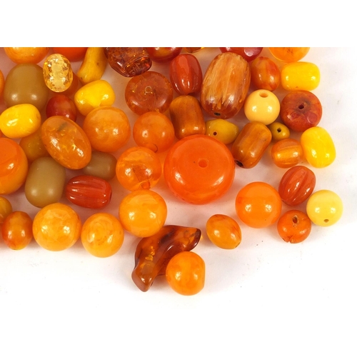 2011 - Loose amber coloured beads, the largest 3cm in length, 280.0g