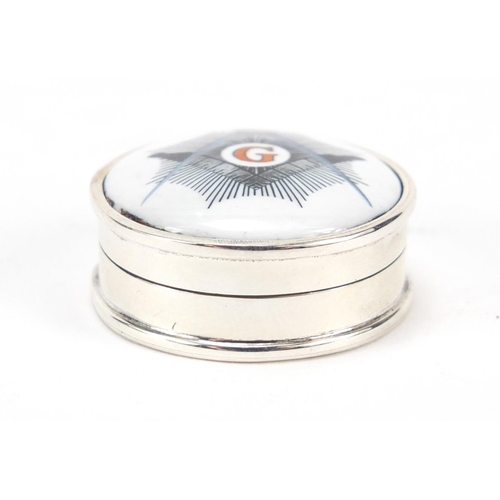 458 - Circular sterling silver patch box, the hinged lid with enamelled Masonic emblem, 2.6cm in diameter,... 