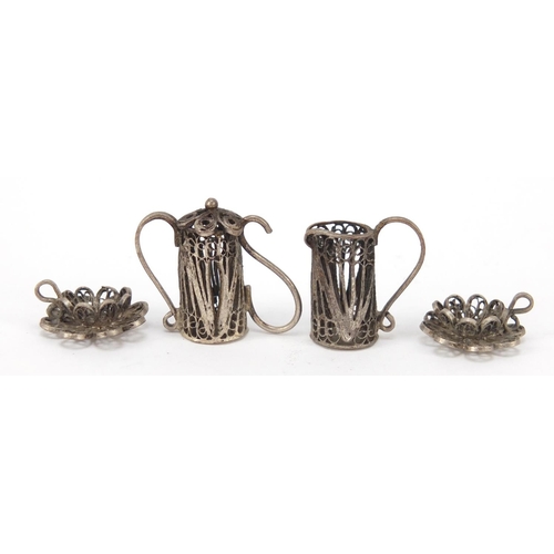 266 - Unmarked filigree silver coloured metal dolls house tea service on tray, the tray 11cm in length, 40... 