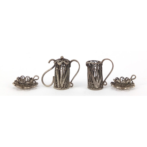 266 - Unmarked filigree silver coloured metal dolls house tea service on tray, the tray 11cm in length, 40... 