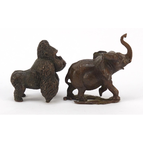 578 - Two Japanese patinated bronze animals of a gorilla and elephant, the largest 5cm high