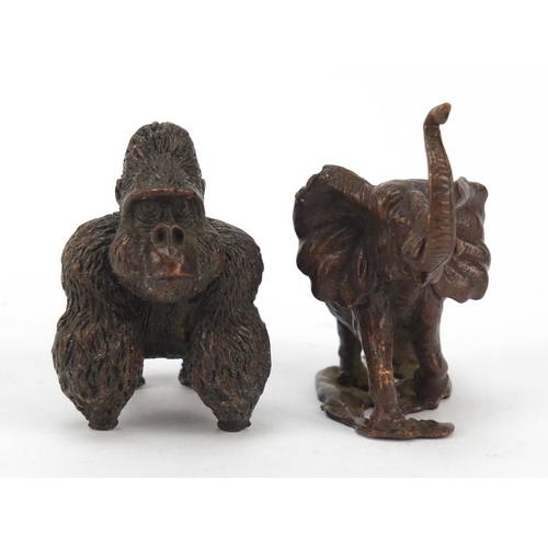 578 - Two Japanese patinated bronze animals of a gorilla and elephant, the largest 5cm high