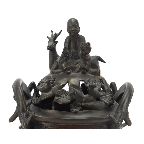 224 - Chinese patinated bronze tripod censer with figural cover, 27cm high