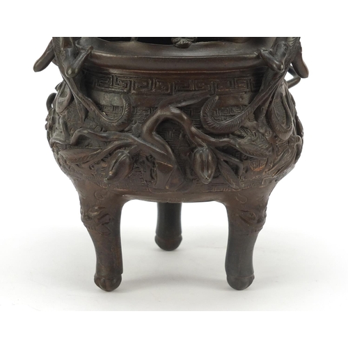 224 - Chinese patinated bronze tripod censer with figural cover, 27cm high