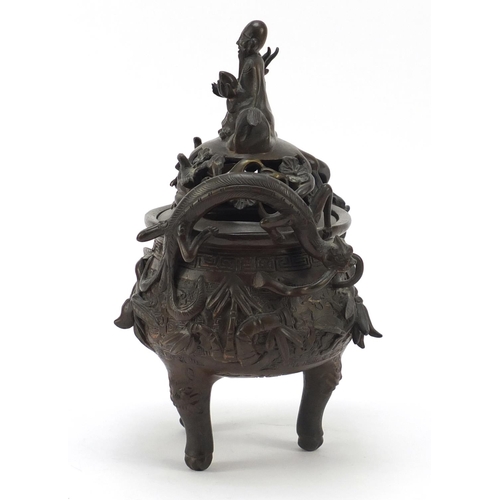 224 - Chinese patinated bronze tripod censer with figural cover, 27cm high