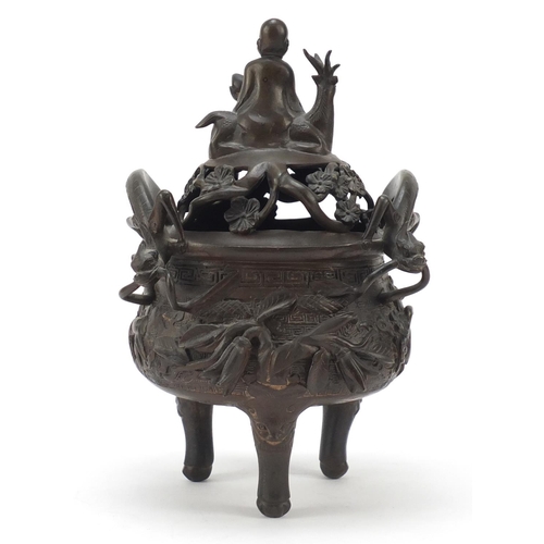 224 - Chinese patinated bronze tripod censer with figural cover, 27cm high