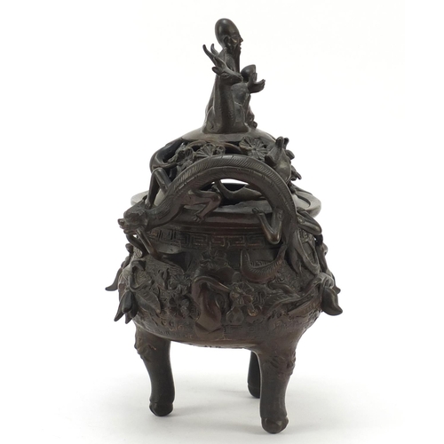 224 - Chinese patinated bronze tripod censer with figural cover, 27cm high