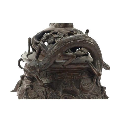 224 - Chinese patinated bronze tripod censer with figural cover, 27cm high