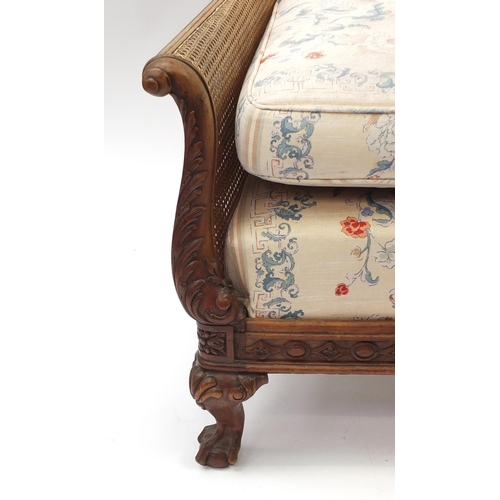 1327 - Victorian walnut framed double bergere three piece suite, each with carved scrolling arms on claw an... 