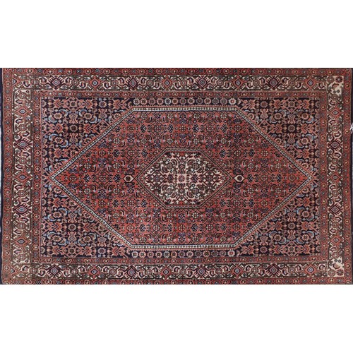 1325 - Iranian wool rug with all over floral design onto a predominantly blue and red ground, 146cm x 91cm